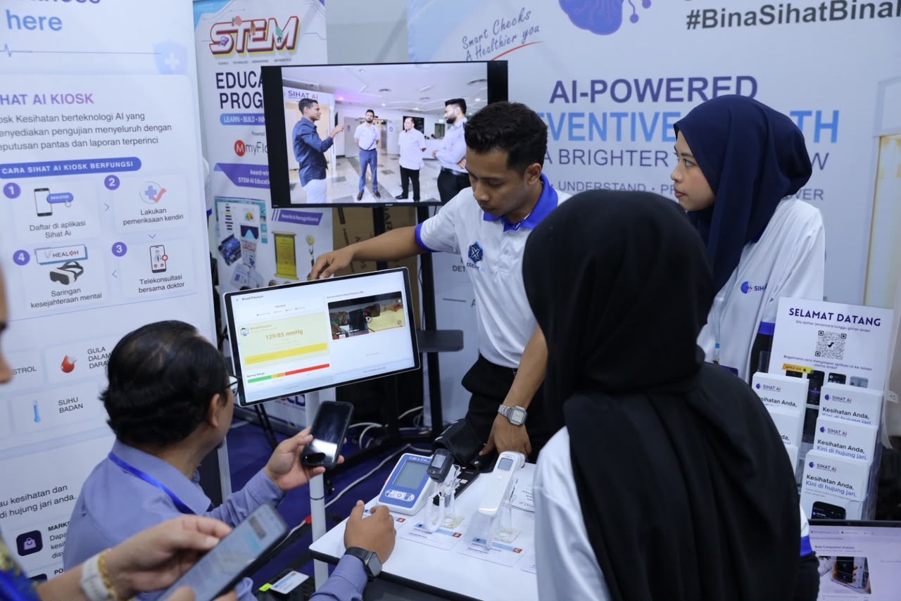 Visitor trying a blood pressure screening at the SIHAT AI booth, Perak State Innovation Convention 2026